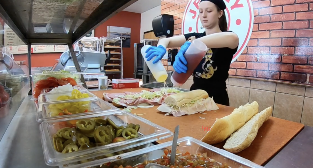 JG screenshot copy A worker at Jersey Giant subs makes a large sandwich
